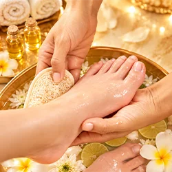 Nail technician working on a client's hand during a manicure
